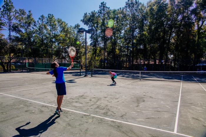 MSP students playing tennis on the tennis courts